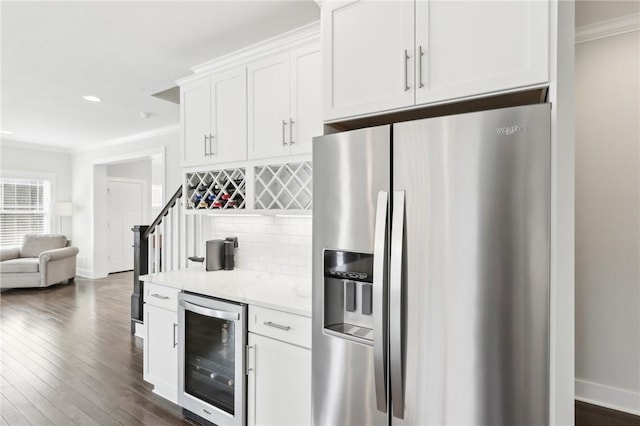 kitchen with stainless steel fridge, beverage cooler, dark wood finished floors, decorative backsplash, and crown molding