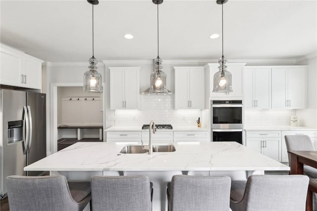 kitchen with stainless steel appliances, a sink, decorative backsplash, and ornamental molding