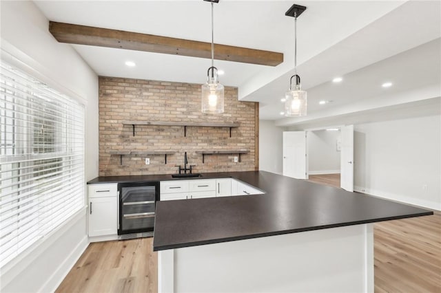 kitchen featuring open shelves, wine cooler, beamed ceiling, and dark countertops