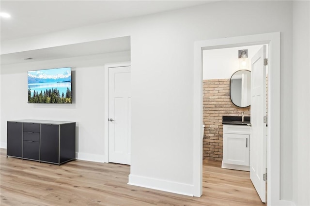 interior space featuring baseboards and light wood-style floors