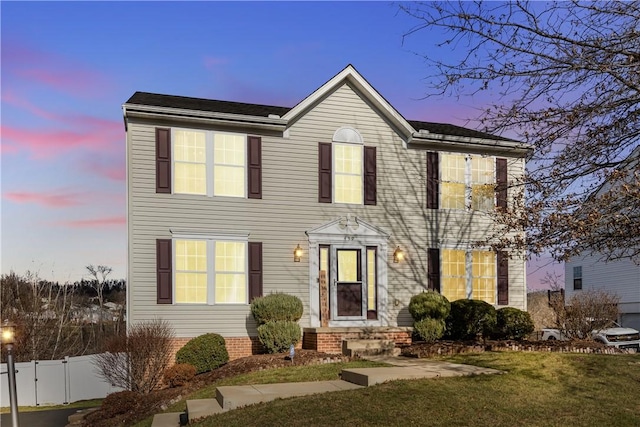 colonial inspired home featuring fence