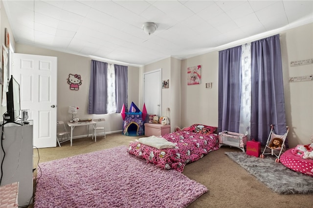 bedroom with ornamental molding and carpet flooring