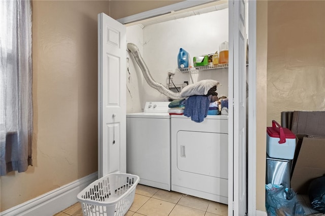 laundry room with laundry area, light tile patterned floors, and independent washer and dryer