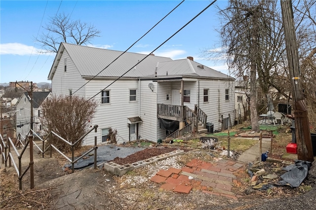 back of property featuring metal roof