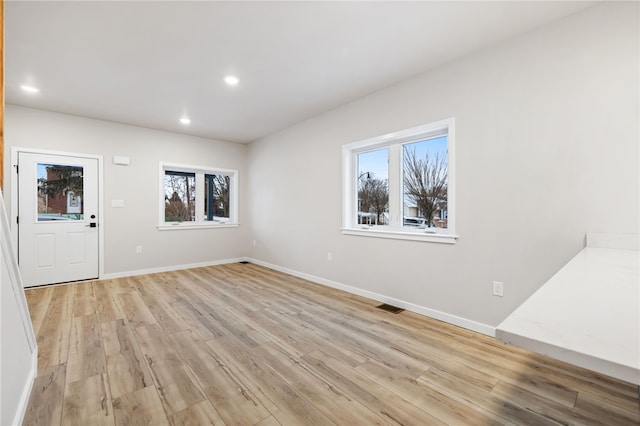 interior space featuring light wood-style flooring, recessed lighting, visible vents, and baseboards