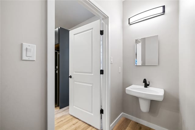 bathroom featuring baseboards and wood finished floors