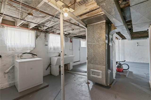 basement with washer / clothes dryer and a sink