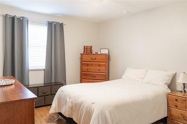 bedroom featuring light wood-style flooring and multiple windows