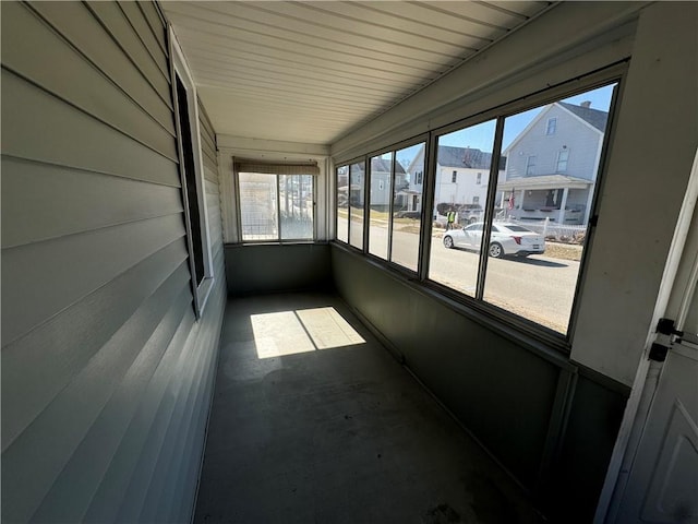 unfurnished sunroom with a residential view