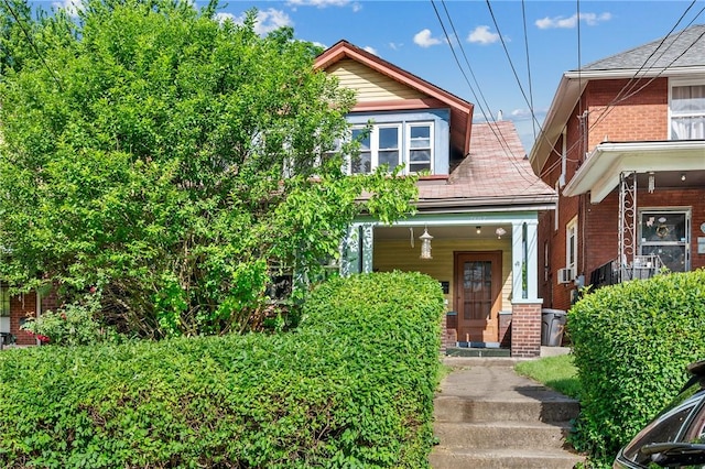 view of front facade with a porch and brick siding