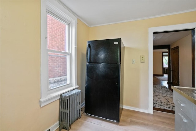 7807 Union Ave, Swissvale, PA 15218 - kitchen featuring freestanding refrigerator, radiator, light wood finished floors, and crown molding