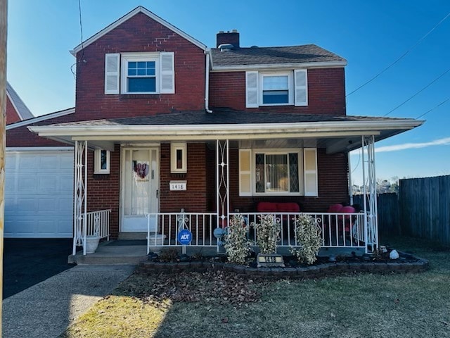 view of front of property with a garage, covered porch, fence, and driveway