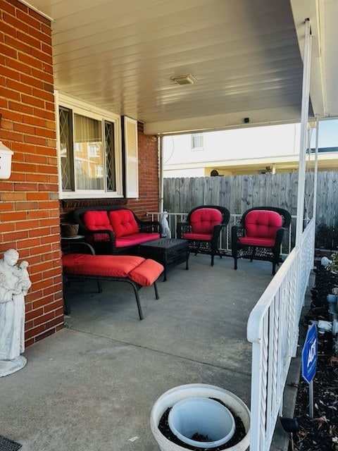 view of patio / terrace featuring outdoor lounge area and fence