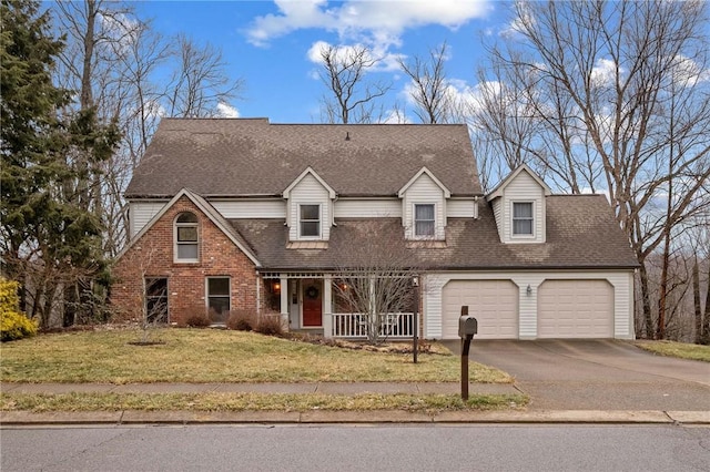 cape cod-style house featuring aphalt driveway, an attached garage, brick siding, a shingled roof, and a front yard