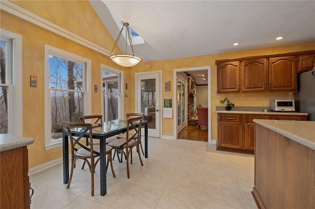 dining area with light tile patterned floors, vaulted ceiling, recessed lighting, and baseboards