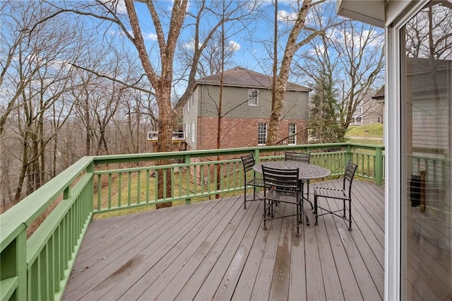 wooden terrace featuring outdoor dining space