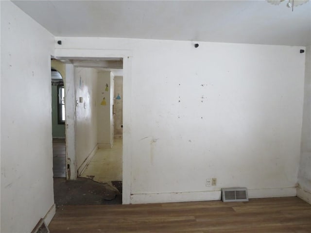 empty room featuring visible vents and wood finished floors