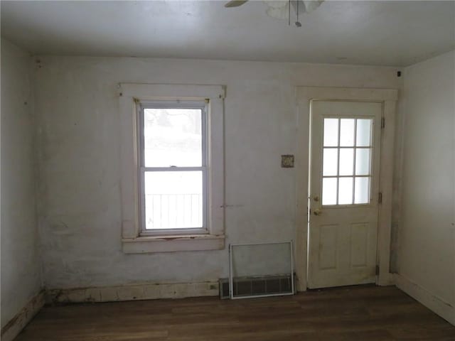 doorway featuring ceiling fan, wood finished floors, visible vents, and a healthy amount of sunlight