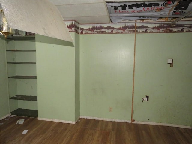 finished basement with dark wood-style floors and baseboards