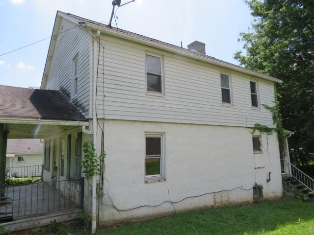 8 Ziskind Rd, East Bethlehem, PA 15333 - view of property exterior with a chimney and stucco siding