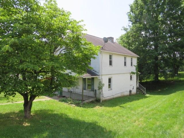 8 Ziskind Rd, East Bethlehem, PA 15333 - back of house with a lawn and a chimney