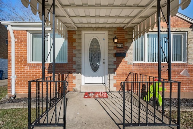 doorway to property with brick siding