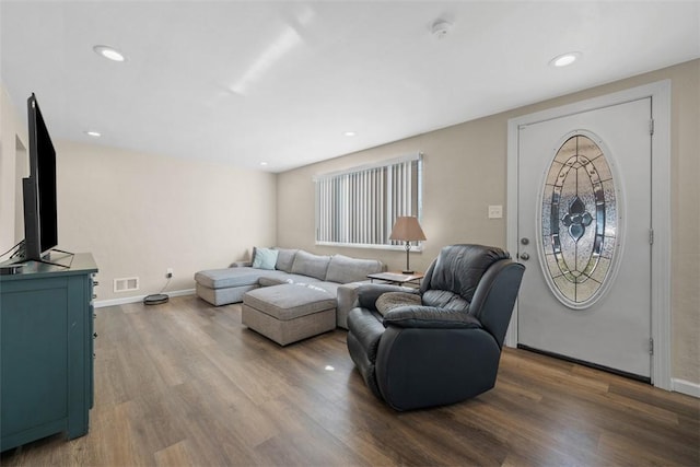 living room with recessed lighting, wood finished floors, visible vents, and baseboards