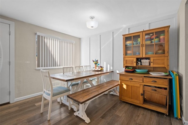 dining room with dark wood finished floors and baseboards