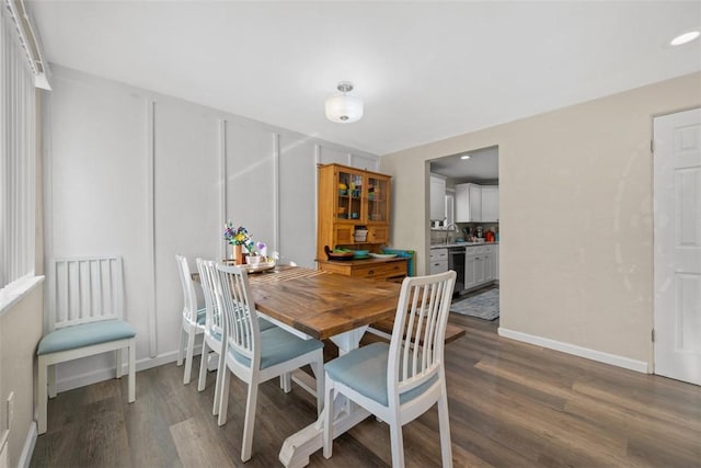 dining room featuring recessed lighting, baseboards, and wood finished floors