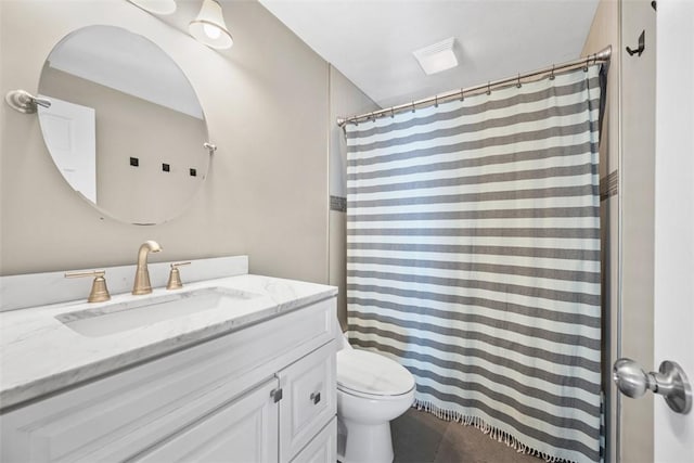 bathroom with toilet, curtained shower, tile patterned flooring, and vanity