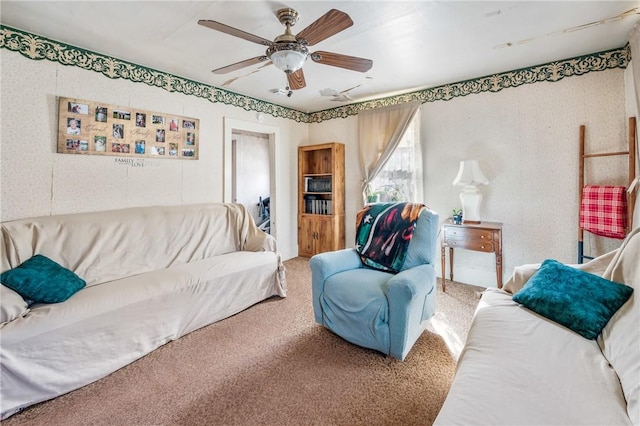 living area with ceiling fan and carpet flooring