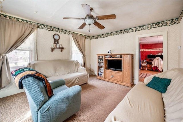 living room featuring light carpet and a ceiling fan