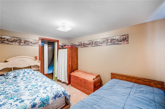 bedroom with a closet and light colored carpet