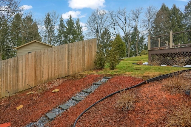 view of yard featuring fence and a deck