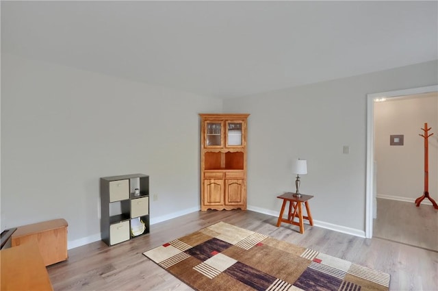 sitting room with light wood finished floors and baseboards