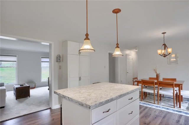 kitchen featuring light countertops, dark wood finished floors, white cabinetry, and a center island