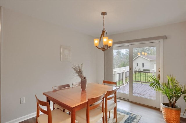 dining space with baseboards and an inviting chandelier