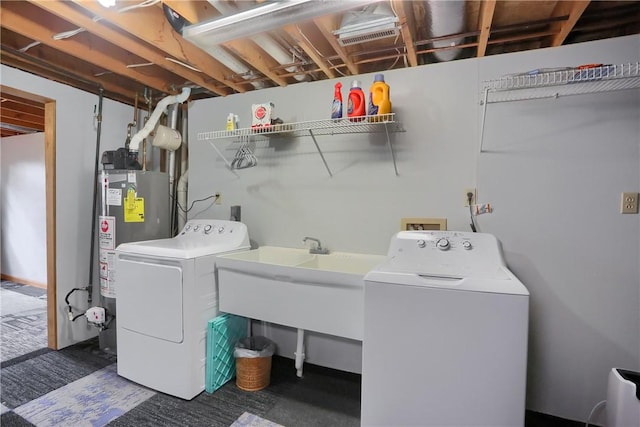 clothes washing area with water heater and washer and clothes dryer