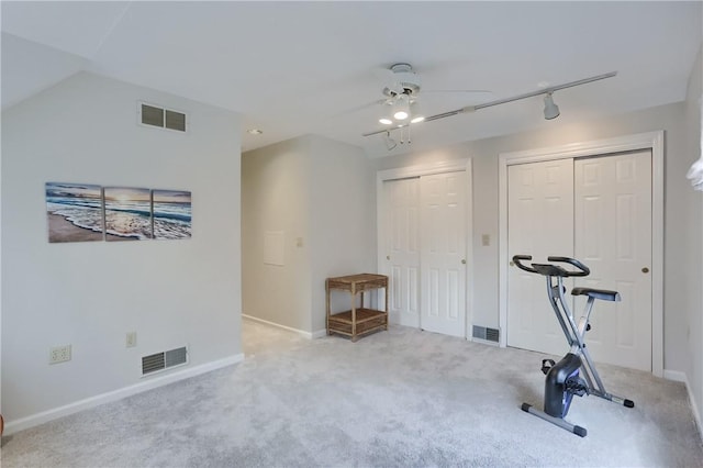 exercise room featuring carpet, ceiling fan, and visible vents