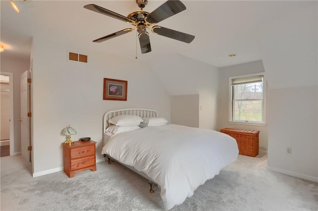 bedroom with baseboards, visible vents, and light colored carpet