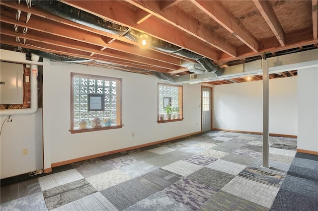 basement featuring electric panel and baseboards