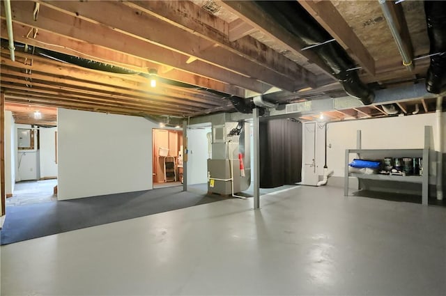 unfinished basement with electric panel and heating unit