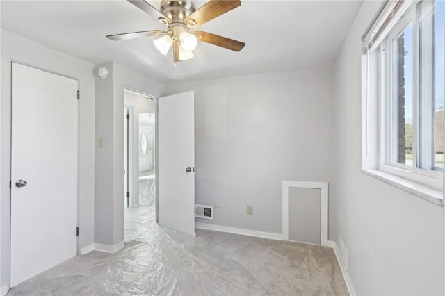 unfurnished bedroom with a ceiling fan, visible vents, and baseboards