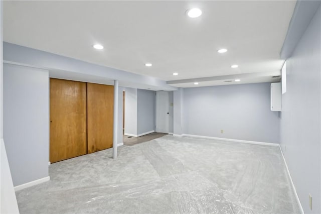 finished basement with baseboards, light carpet, and recessed lighting