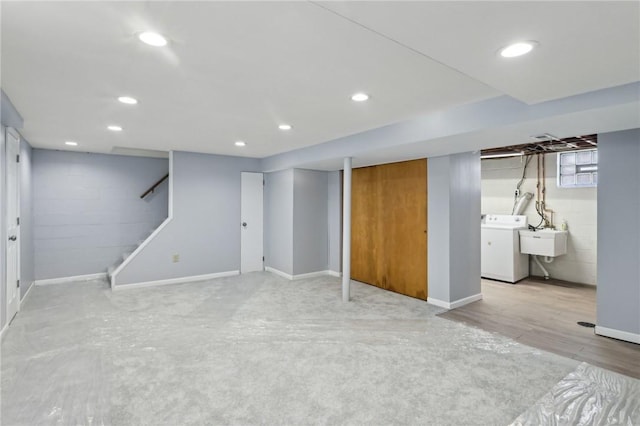 below grade area featuring washer / dryer, stairs, a sink, and recessed lighting