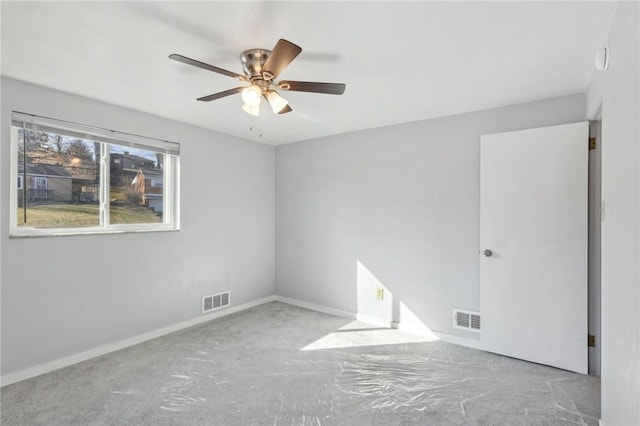 empty room with a ceiling fan, visible vents, and baseboards