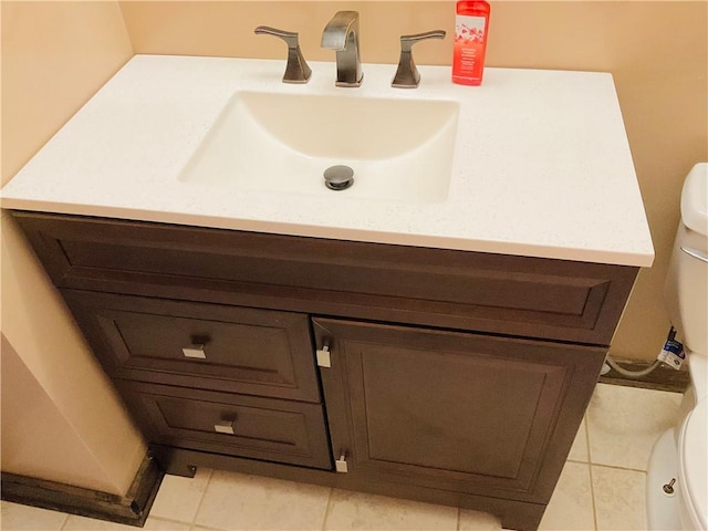 bathroom featuring toilet, tile patterned flooring, and vanity