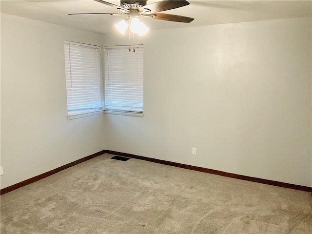 unfurnished room featuring light carpet, visible vents, and baseboards