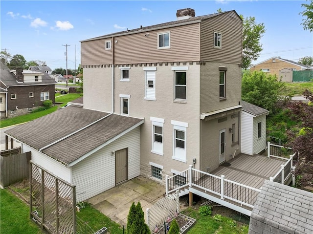 2101 Lonsdale St, Reserve, PA 15212 - rear view of property featuring a chimney, a wooden deck, fence, a shingled roof, and a patio area