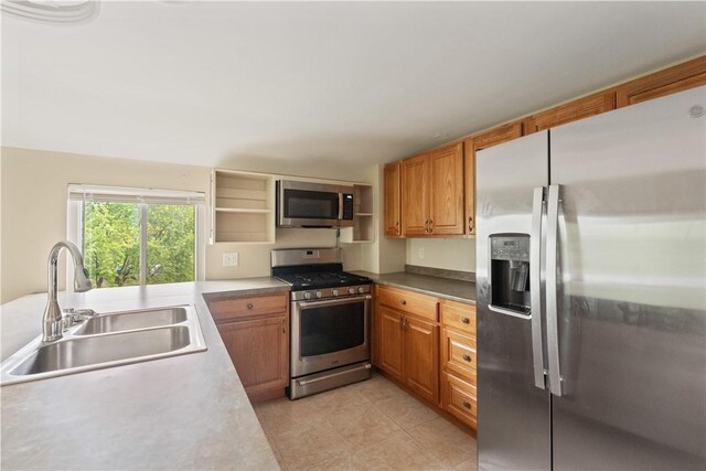 2101 Lonsdale St, Reserve, PA 15212 - kitchen with stainless steel appliances, a sink, light tile patterned floors, and brown cabinets